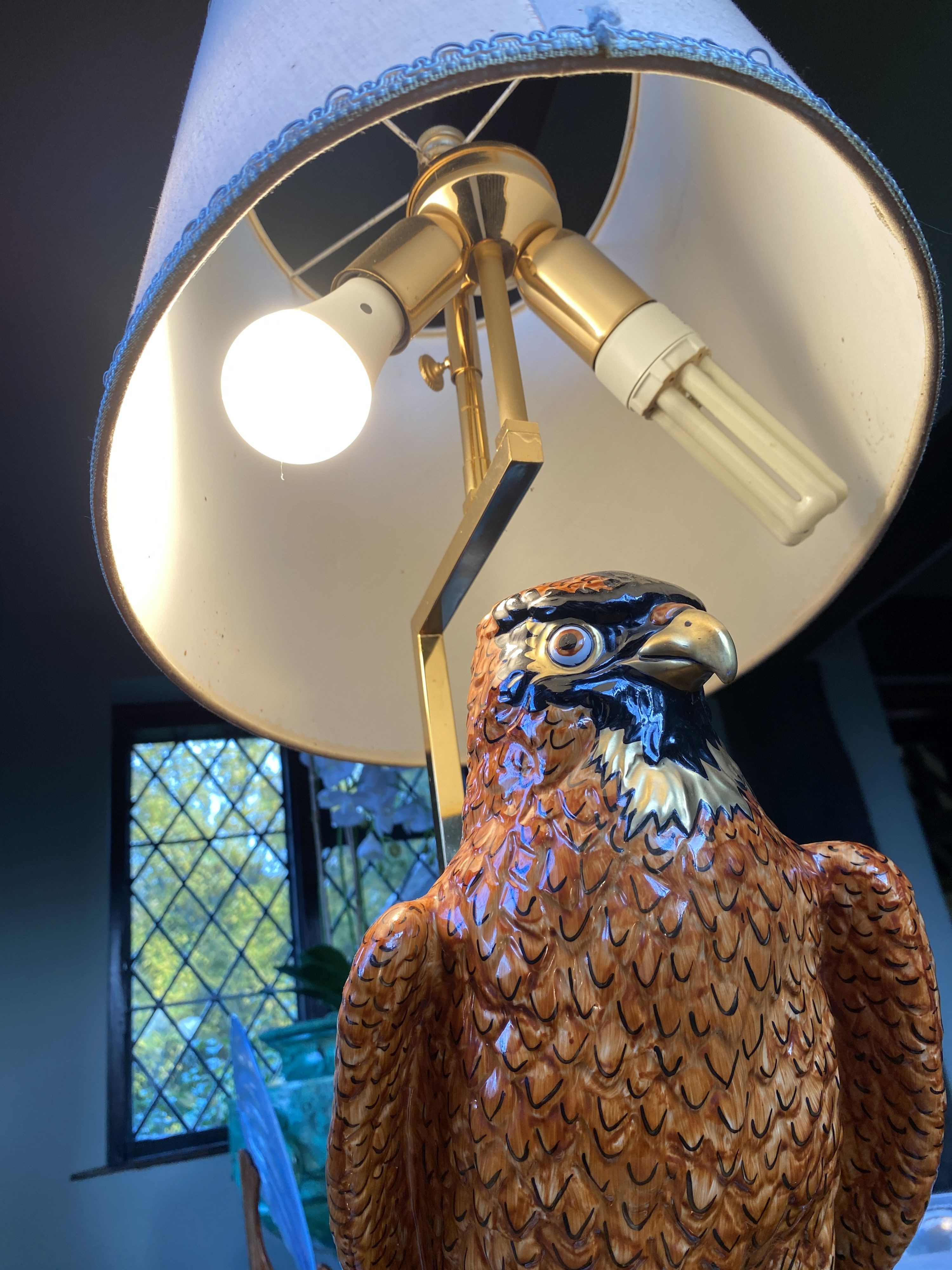 A Continental porcelain owl lamp base, with lacquered brass mounts, height of base 45cm